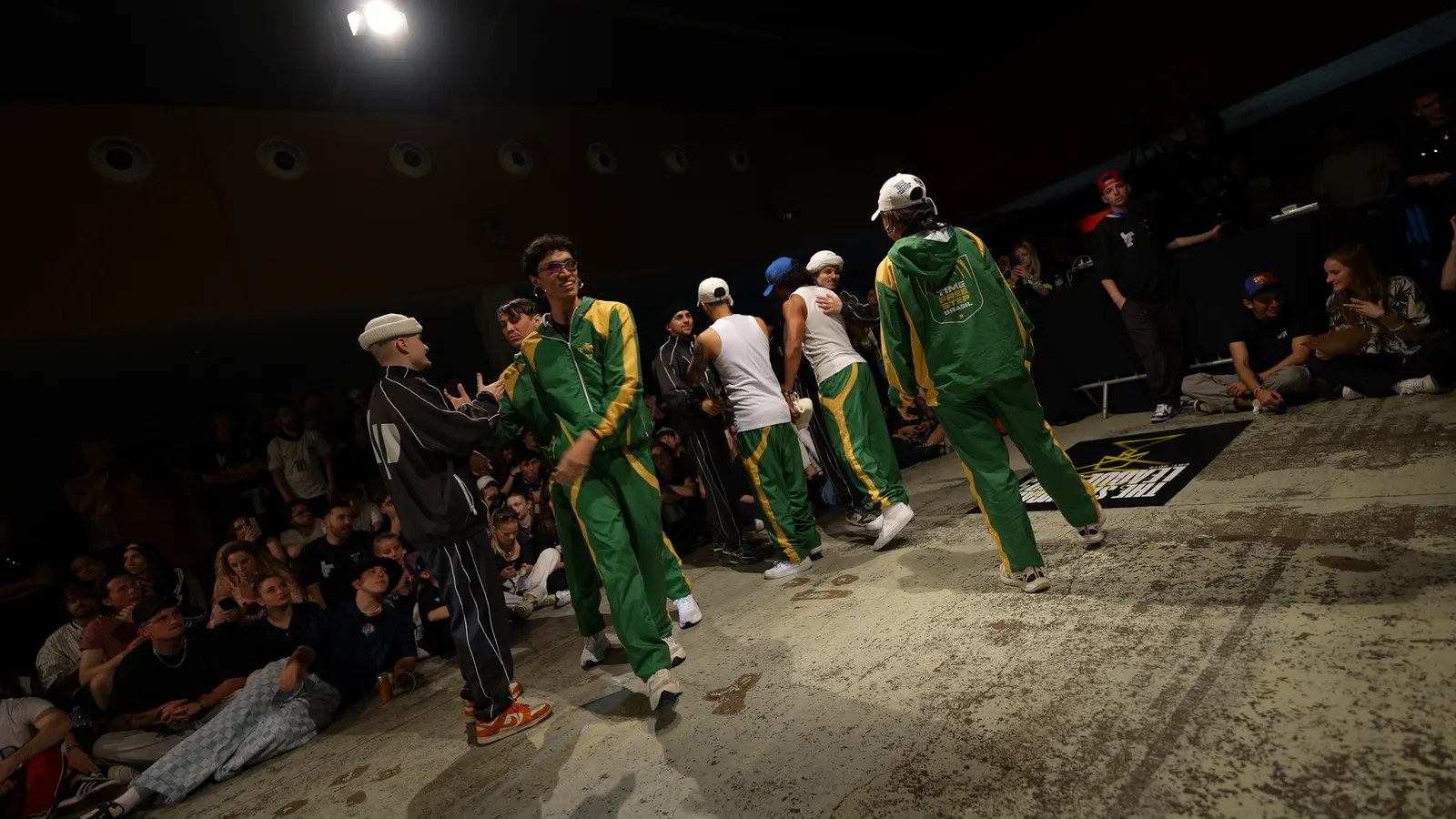 A crew in green and yellow tracksuits on the floor