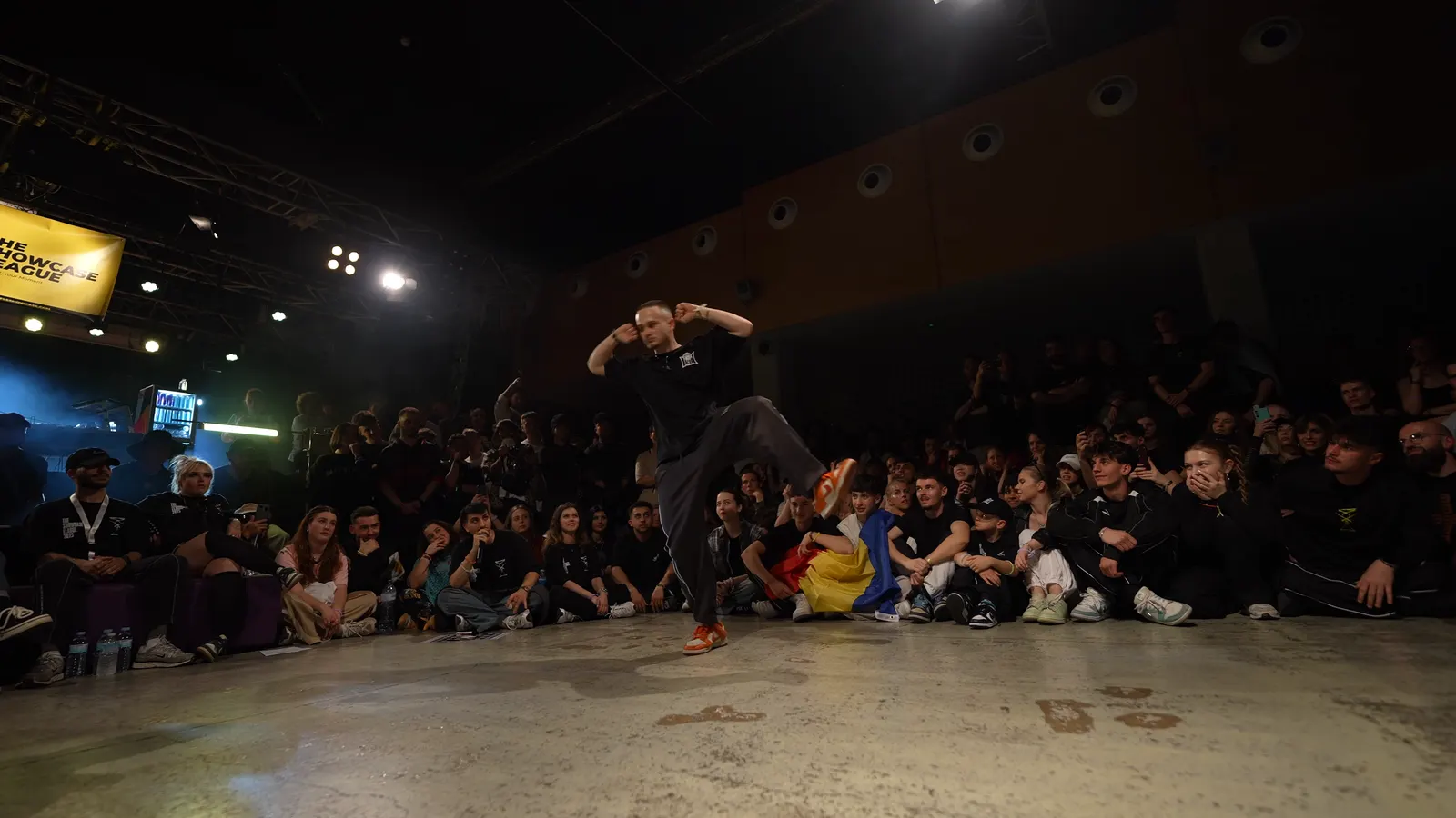 A single dancer on the floor, the audience all around