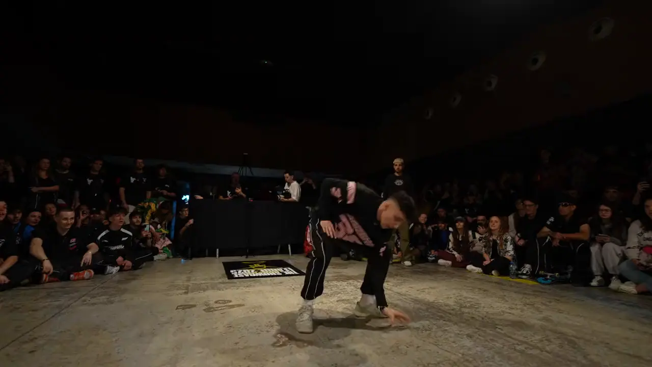 A shuffle solo in front of an audience seated around the floor